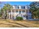 Two-story house with a front porch and palm trees at 4154 Jean Laffite Rd, Hollywood, SC 29449