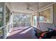 Relaxing screened porch with ceiling fan and wooden swing at 4154 Jean Laffite Rd, Hollywood, SC 29449