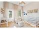 Bedroom with a crib, changing table, and ample natural light at 416 Bank St, Mount Pleasant, SC 29464