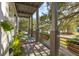 Bright covered porch with seating area and lush tropical plants at 416 Bank St, Mount Pleasant, SC 29464