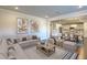 Open living room showcasing a sectional sofa, coffee table, and view into the kitchen and dining area at 470 White Magnolia St, Moncks Corner, SC 29461