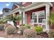 Landscaped front yard with palm trees and rocking chairs at 5004 W Liberty Meadows Dr, Summerville, SC 29485