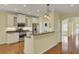 Open concept kitchen with island and stainless steel appliances at 5004 W Liberty Meadows Dr, Summerville, SC 29485