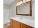 Clean bathroom with wood cabinets and large mirror at 5463 Altamaha Dr, North Charleston, SC 29420