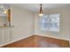 Simple dining room with hardwood floors and large windows at 5463 Altamaha Dr, North Charleston, SC 29420