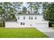 Rear view of a two story white house with a two car garage at 5655 Captain Kidd Rd, Hollywood, SC 29449