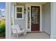 Inviting front porch with rocking chair and stylish front door at 765 Opal Wing St, Moncks Corner, SC 29461