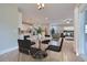 Open concept dining area with glass table and black chairs, overlooking the living room at 8623 Connor Ct, North Charleston, SC 29406