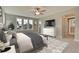 Spacious main bedroom with plush bed, large windows, and en-suite bathroom at 8623 Connor Ct, North Charleston, SC 29406