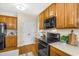 Kitchen with wood cabinets, granite counters, and black appliances at 1014 Ariel Ct, Summerville, SC 29485