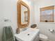 Simple bathroom with a modern vanity and wicker mirror at 1024 Holcombe Rd, Hanahan, SC 29410