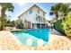 Inviting rectangular pool with brick patio and string lights, perfect for entertaining at 109 Carolina Blvd, Isle of Palms, SC 29451