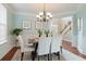 Elegant dining room with hardwood floors, chandelier, and view of staircase at 113 History Ln, Summerville, SC 29485