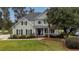 Two-story house with a large front porch and well-maintained lawn at 113 History Ln, Summerville, SC 29485