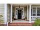 Front entrance with black door and welcoming decor at 113 History Ln, Summerville, SC 29485