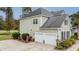 Two-car garage with a long driveway and additional parking at 113 History Ln, Summerville, SC 29485