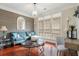 Cozy living room with teal couch and wood-paneled wall at 113 History Ln, Summerville, SC 29485