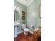 Charming powder room with pedestal sink and hardwood floors at 113 History Ln, Summerville, SC 29485