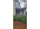 House side view, showcasing porch and landscaping at 1150 King St, Charleston, SC 29403