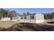 Side view of a manufactured home with gray siding and wooden steps at 120 Wilder Rd, Saint Stephen, SC 29479