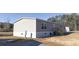 Rear view of a manufactured home showcasing gray siding and a back door at 120 Wilder Rd, Saint Stephen, SC 29479