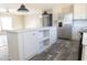 Kitchen island with marble top, white cabinets, and open shelving at 120 Wilder Rd, Saint Stephen, SC 29479