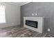 Living room with a modern fireplace and wood-look flooring at 120 Wilder Rd, Saint Stephen, SC 29479
