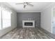 Bright living room featuring a modern fireplace and wood-look flooring at 120 Wilder Rd, Saint Stephen, SC 29479