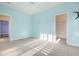 Light blue bedroom with carpeted floors and access to another room at 1212 Topside Dr, Charleston, SC 29414