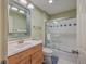 Clean bathroom with shower/tub combo, wood vanity, and blue and white tile at 1248 Creek Watch Trce, Seabrook Island, SC 29455