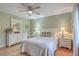 Bedroom with white dresser, light green walls, hardwood floors and comfortable bed at 1248 Creek Watch Trce, Seabrook Island, SC 29455