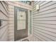 Front door entry with storm door and sidelight window at 1248 Creek Watch Trce, Seabrook Island, SC 29455