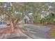 Quaint front yard with mature trees and parking area at 1248 Creek Watch Trce, Seabrook Island, SC 29455