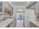 Bright kitchen features white countertops, gray cabinets, and a view to the back patio at 1248 Creek Watch Trce, Seabrook Island, SC 29455