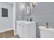 Updated bathroom with a white vanity and gray shiplap walls at 1300 Park West Blvd # 417, Mount Pleasant, SC 29466