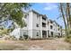 Apartment building with landscaping and wooded area at 1300 Park West Blvd # 417, Mount Pleasant, SC 29466