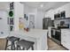 Modern white kitchen with stainless steel appliances and island at 1300 Park West Blvd # 417, Mount Pleasant, SC 29466