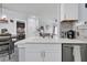 White kitchen with stainless steel appliances and breakfast bar at 1300 Park West Blvd # 417, Mount Pleasant, SC 29466