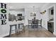 Open concept kitchen and dining area with stainless steel appliances and breakfast bar at 1300 Park West Blvd # 417, Mount Pleasant, SC 29466