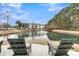 Relaxing view of a pond and community building from Adirondack chairs at 1300 Park West Blvd # 417, Mount Pleasant, SC 29466