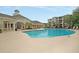 Community pool and clubhouse with lush landscaping at 1300 Park West Blvd # 417, Mount Pleasant, SC 29466