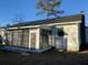 House exterior showcasing a screened sunroom addition at 148 Ponderosa Dr, Ladson, SC 29456