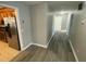 Bright hallway with laminate flooring, leading to bedrooms and kitchen at 148 Ponderosa Dr, Ladson, SC 29456