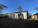 Backyard view of house with screened sunroom addition at 148 Ponderosa Dr, Ladson, SC 29456