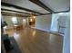 Living room with hardwood floors, exposed beams, and fireplace at 148 Ponderosa Dr, Ladson, SC 29456