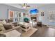 Cozy living room with fireplace, hardwood floors, and large windows at 151 Belleplaine Dr, Goose Creek, SC 29445