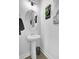 Small bathroom with pedestal sink, round mirror, and gray walls at 157 Pocket Bend Cir # B, Summerville, SC 29486