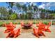 Community fire pit with orange Adirondack chairs for gatherings at 157 Pocket Bend Cir # B, Summerville, SC 29486