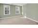 Bright bedroom with neutral carpeting and two large windows at 1724 Bee Balm Rd, Johns Island, SC 29455