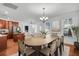 Dining area with hardwood floors and a large oval table, next to kitchen at 1724 Bee Balm Rd, Johns Island, SC 29455